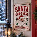 Santa Stops Here — Good Kids Mostly Christmas aluminum sign in a realistic holiday entryway