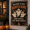 Welcome to Our Haunted Home — Same People, Just More Ghosts aluminum Halloween sign on a realistic decorated porch